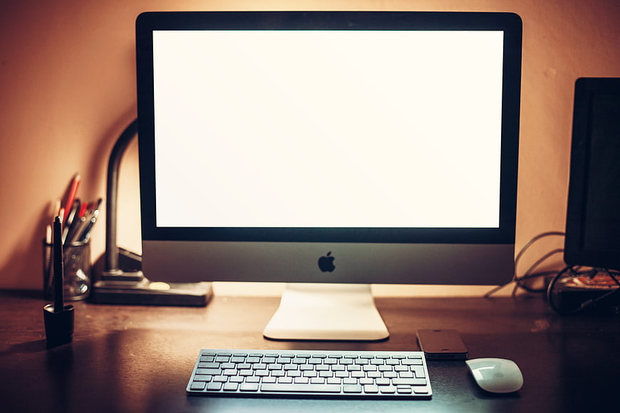 Modern iMac Workspace with Blank Screen and Accessories