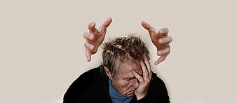 Stressed Senior Man With Hands Raised In Distress Against Beige Background