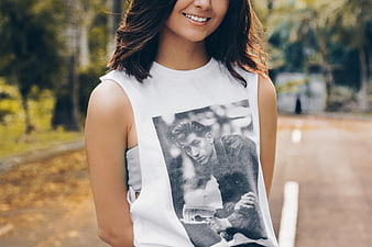 Smiling Woman Wearing Graphic Tee in Autumn Park