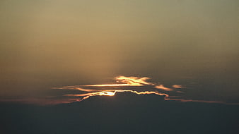 Dramatic sunset light breaking through dark clouds