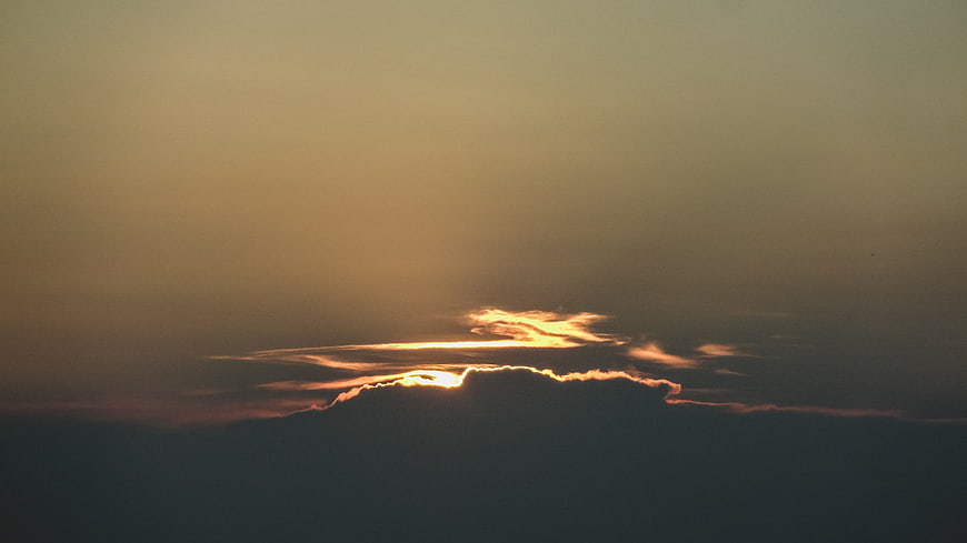Dramatic sunset light breaking through dark clouds