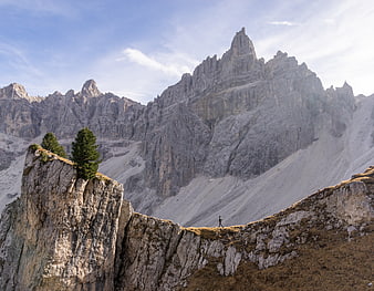 Lone Hiker on Rocky Ridge with Majestic Dolomites Mountain Peak
