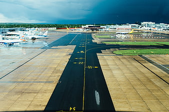 Airport tarmac with dramatic storm clouds overhead