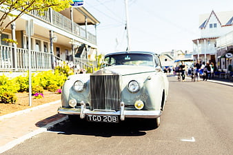Classic Silver Rolls Royce Parked on Sunny Street