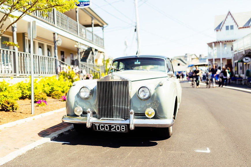 Classic Silver Rolls Royce Parked on Sunny Street