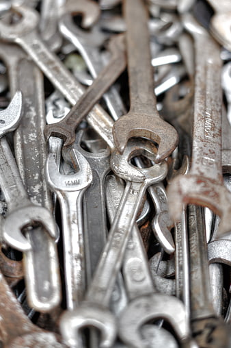 Close-up of rusty metal wrenches and spanners pile