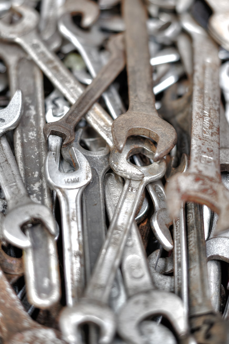 Close-up of rusty metal wrenches and spanners pile