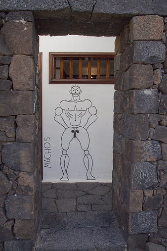 Stone archway framing humorous macho graffiti art