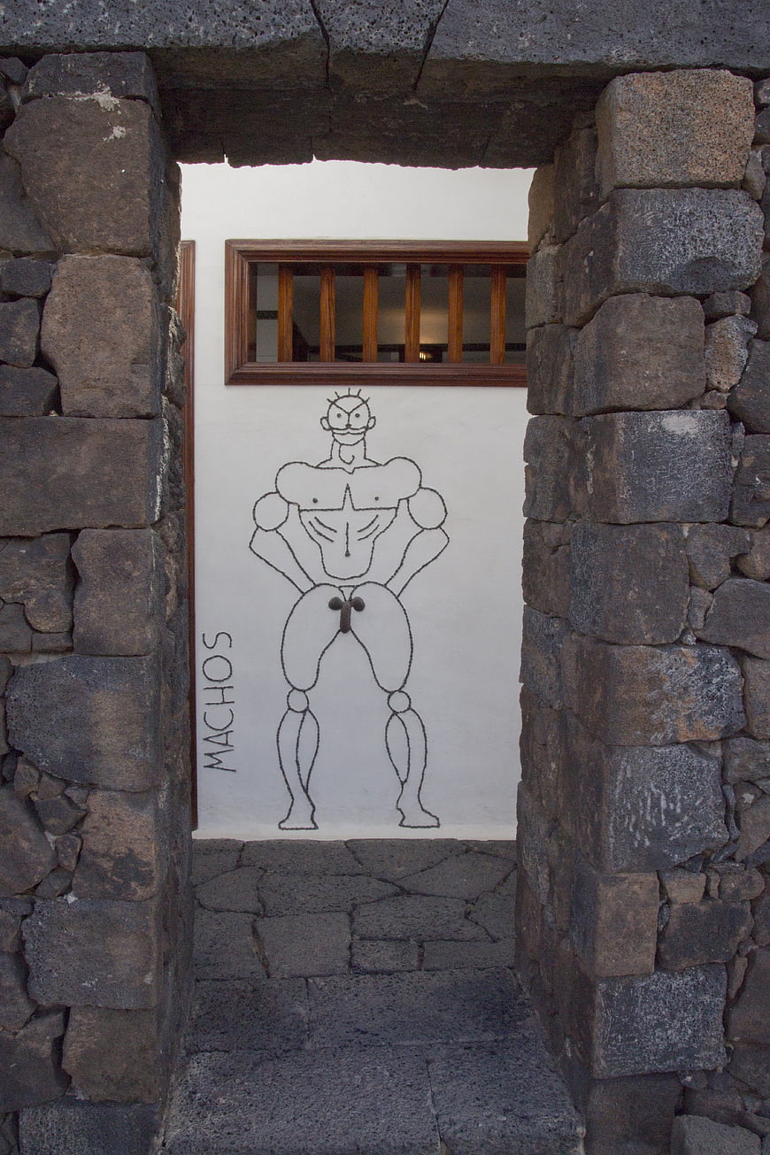Stone archway framing humorous macho graffiti art
