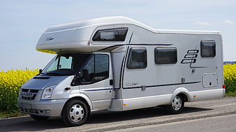 White Hymer Campervan Parked by Yellow Rapeseed Field