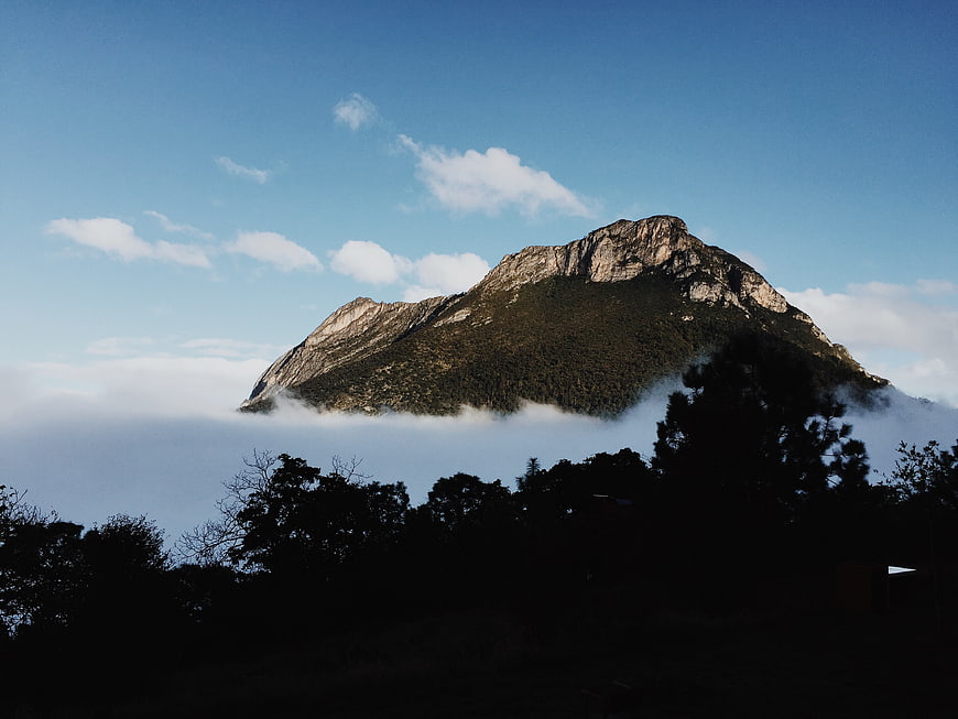 Majestic Mountain Peak Rising Above Sea of Clouds