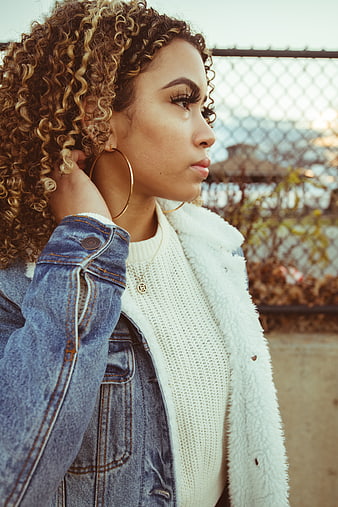 Stylish Woman with Curly Hair in Denim Jacket