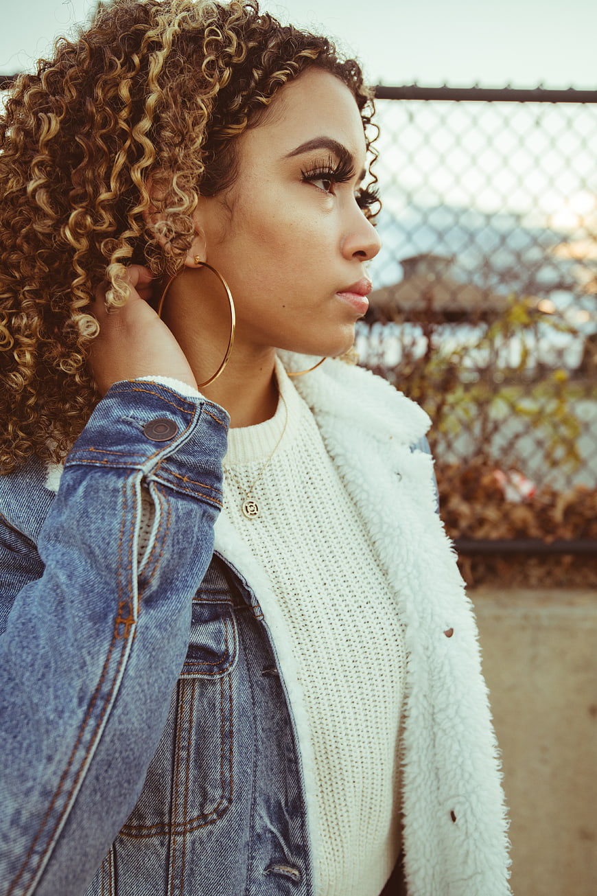 Stylish Woman with Curly Hair in Denim Jacket