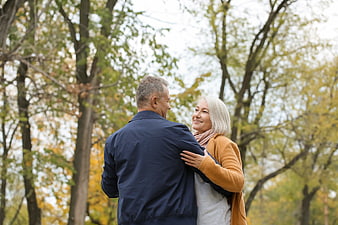 Happy Senior Couple Embracing in Autumn Park