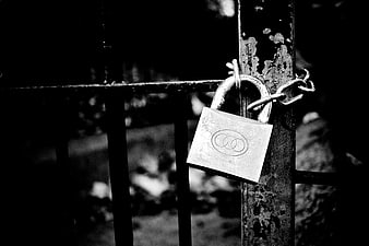Vintage Padlock on Rusty Metal Gate in Black and White