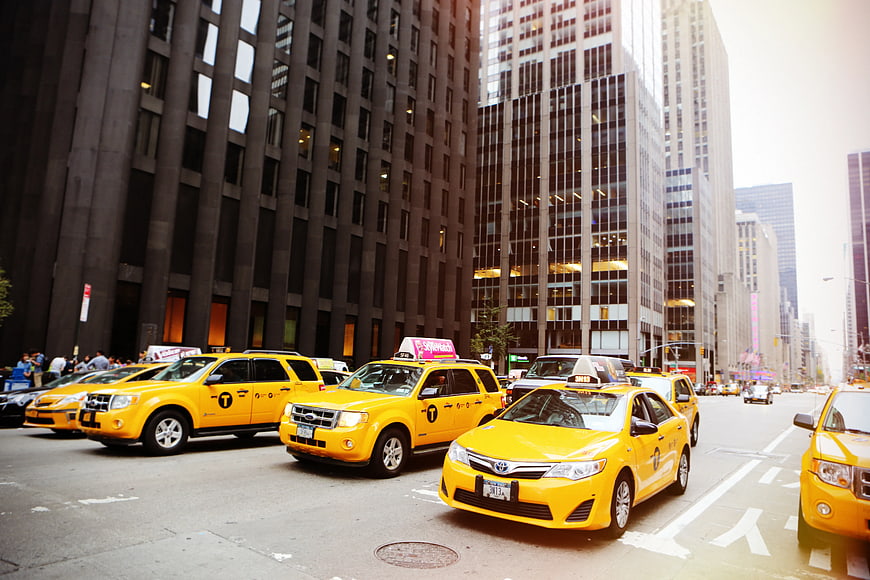 Yellow taxis lined up on busy New York City street