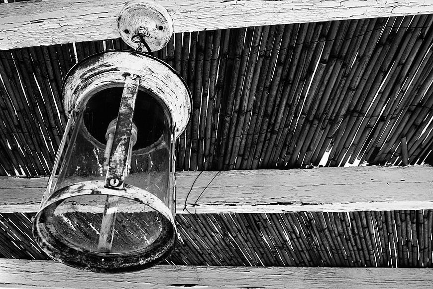 Vintage black and white hanging lamp with bamboo ceiling