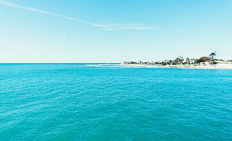 Aerial View of Turquoise Ocean and Sandy Beach Coastline