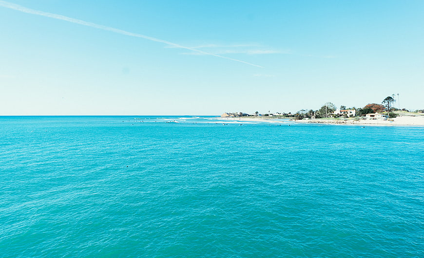Aerial View of Turquoise Ocean and Sandy Beach Coastline