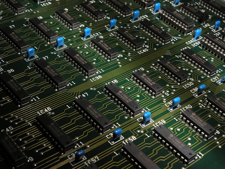 Close-up of green circuit board with black microchips