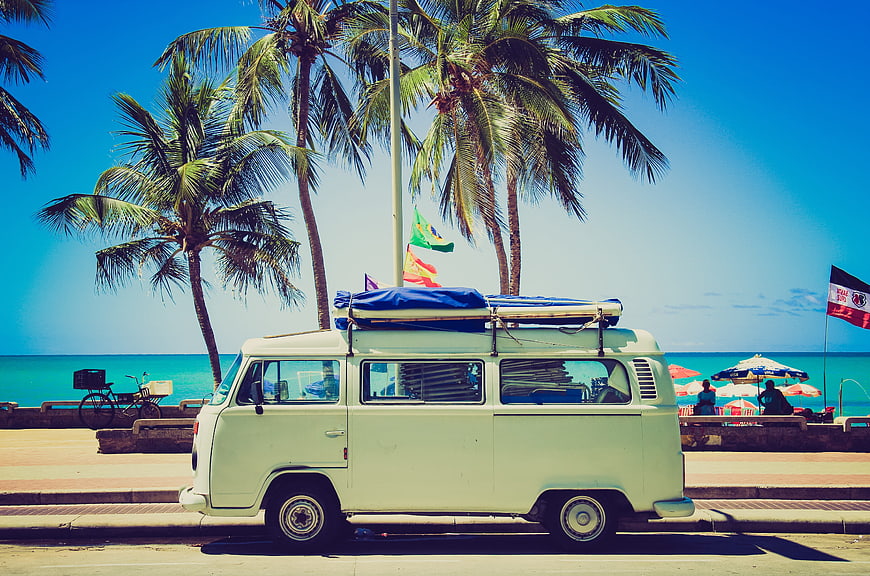 Vintage white van parked on tropical beach road