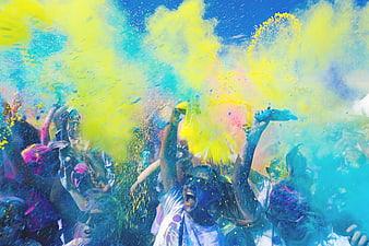 Crowd throwing colorful powder at Holi festival celebration