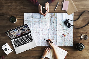 Top View Travel Planning with Map and Laptop