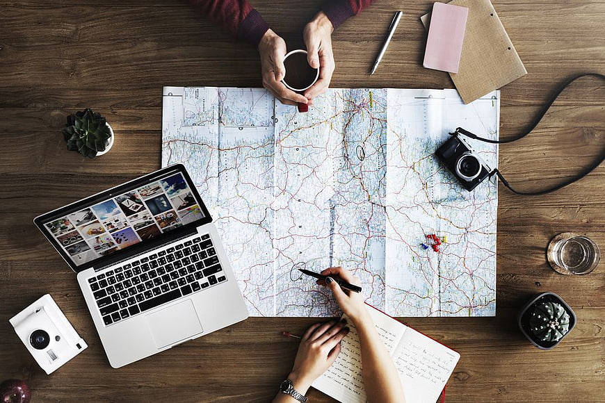 Top View Travel Planning with Map and Laptop