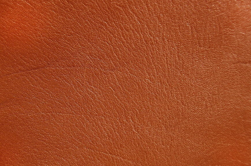 Close-up texture of orange leather material background