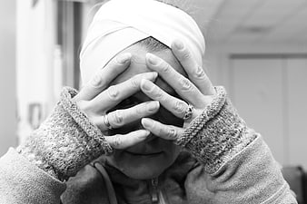 Black and white portrait of woman with headscarf covering eyes