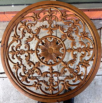 Top view of ornate round metal table with floral pattern