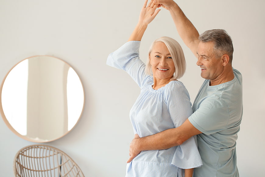 Happy Senior Couple Dancing Together at Home