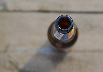 Top View of Open Amber Beer Bottle on Concrete