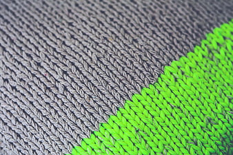 Close-up of gray and neon green knitted wool texture