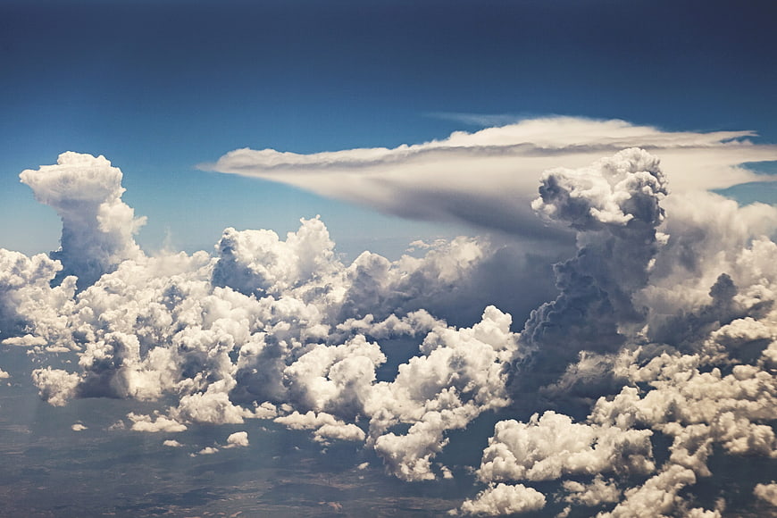 Aerial view of dramatic cumulus clouds and blue sky