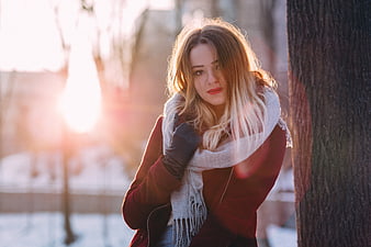 Young Woman in Winter Coat and Scarf by Tree