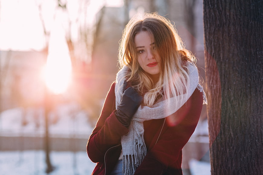 Young Woman in Winter Coat and Scarf by Tree