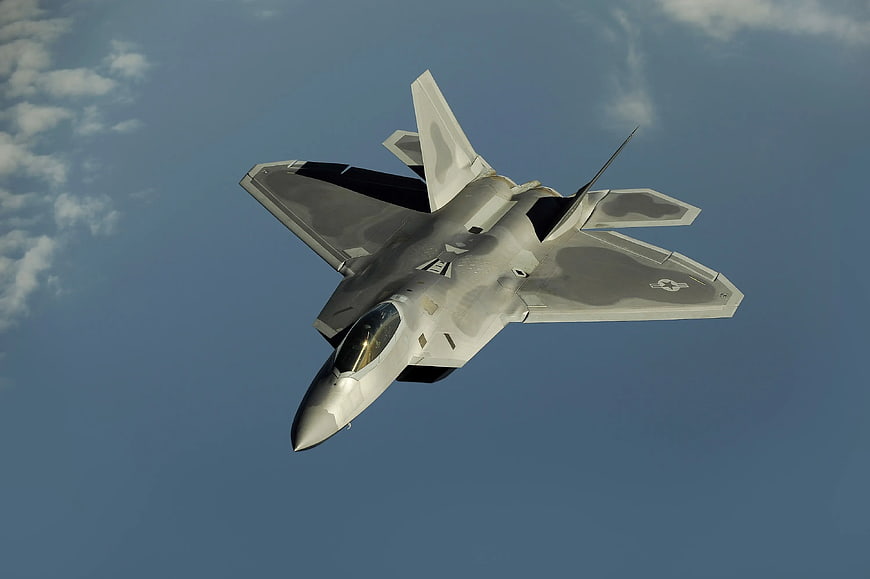 F-22 Raptor Stealth Fighter Jet Flying in Blue Sky