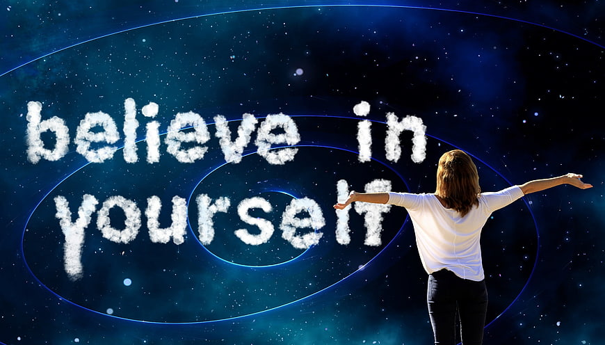 Woman with arms outstretched facing cloud text believe in yourself