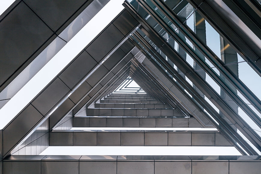 Modern triangular architectural structure with metal and glass