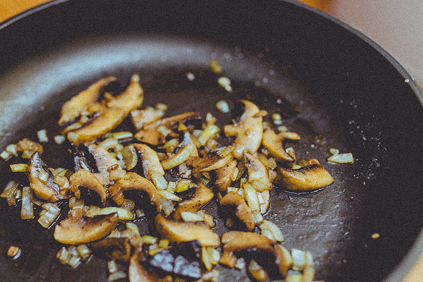 Sautéed Mushrooms and Onions Cooking in a Pan