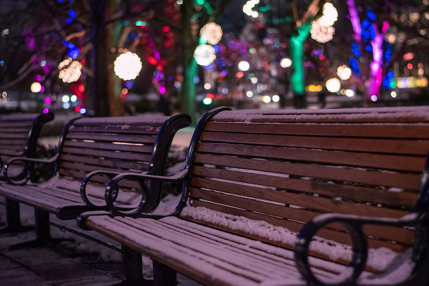 Snowy Park Benches with Colorful Bokeh Lights at Night