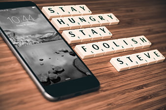 Scrabble tiles spelling Steve Jobs quote on wooden table
