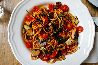 Overhead shot of zucchini noodles with tomato sauce and mushrooms