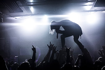 Silhouette of Rock Singer Performing on Stage with Crowd