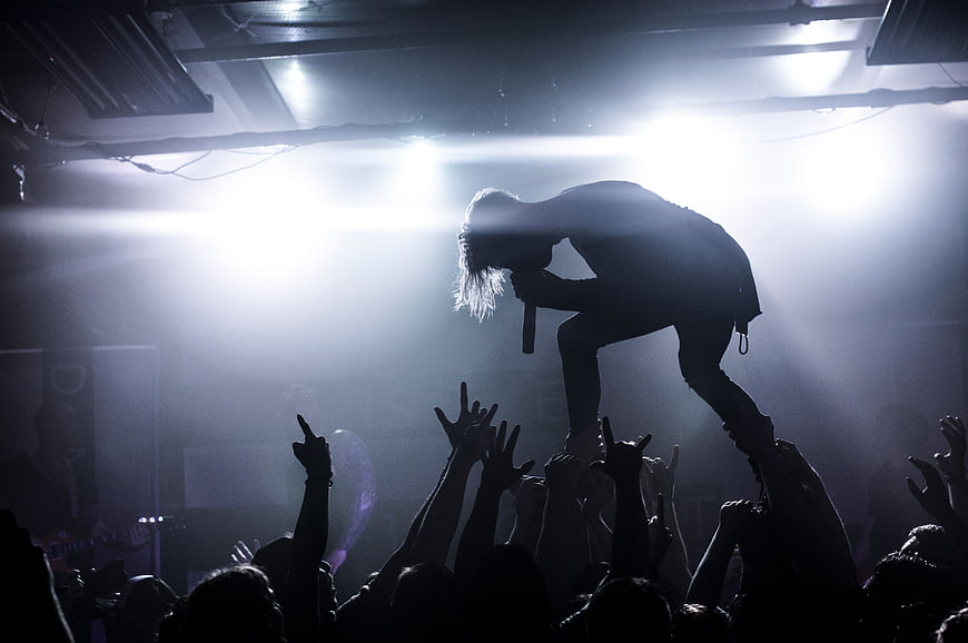 Silhouette of Rock Singer Performing on Stage with Crowd