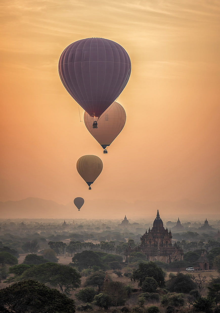 Hot Air Balloons Flying Over Ancient Temples in Bagan at Sunrise