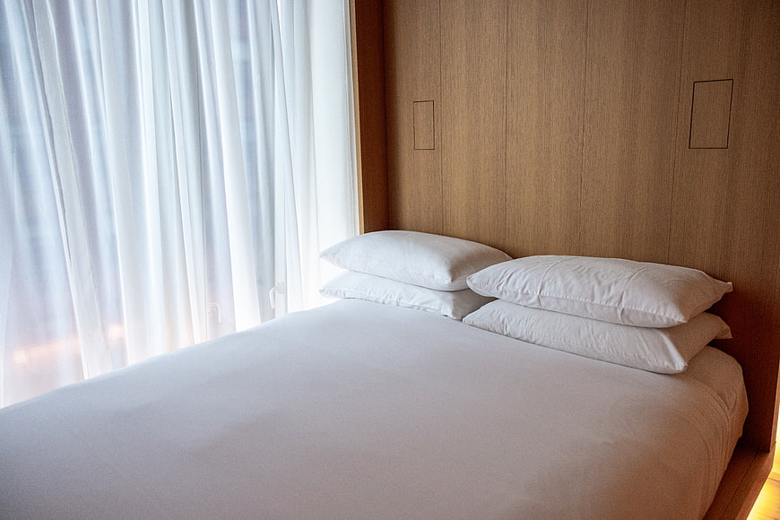 Modern Hotel Bedroom with White Bedding and Wooden Wall