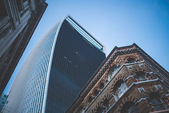 Low Angle View of Modern Skyscraper and Historic Brick Building