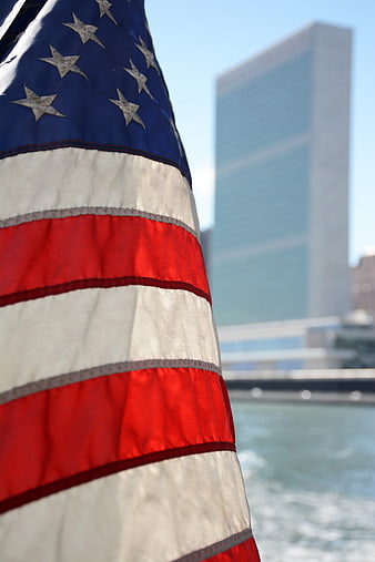 American Flag Close-Up with United Nations Headquarters Background